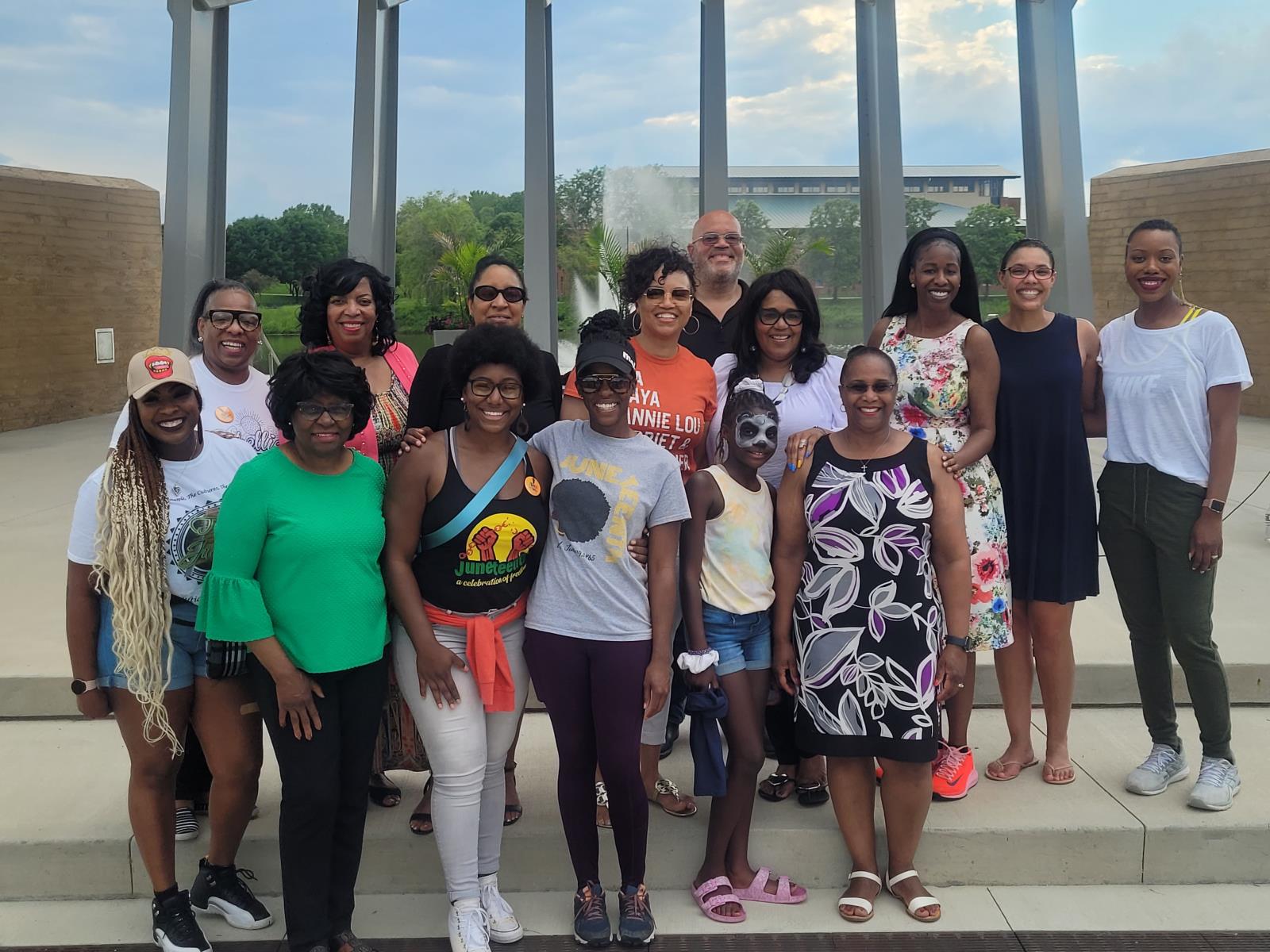 Group of 15 community members posing and smiling