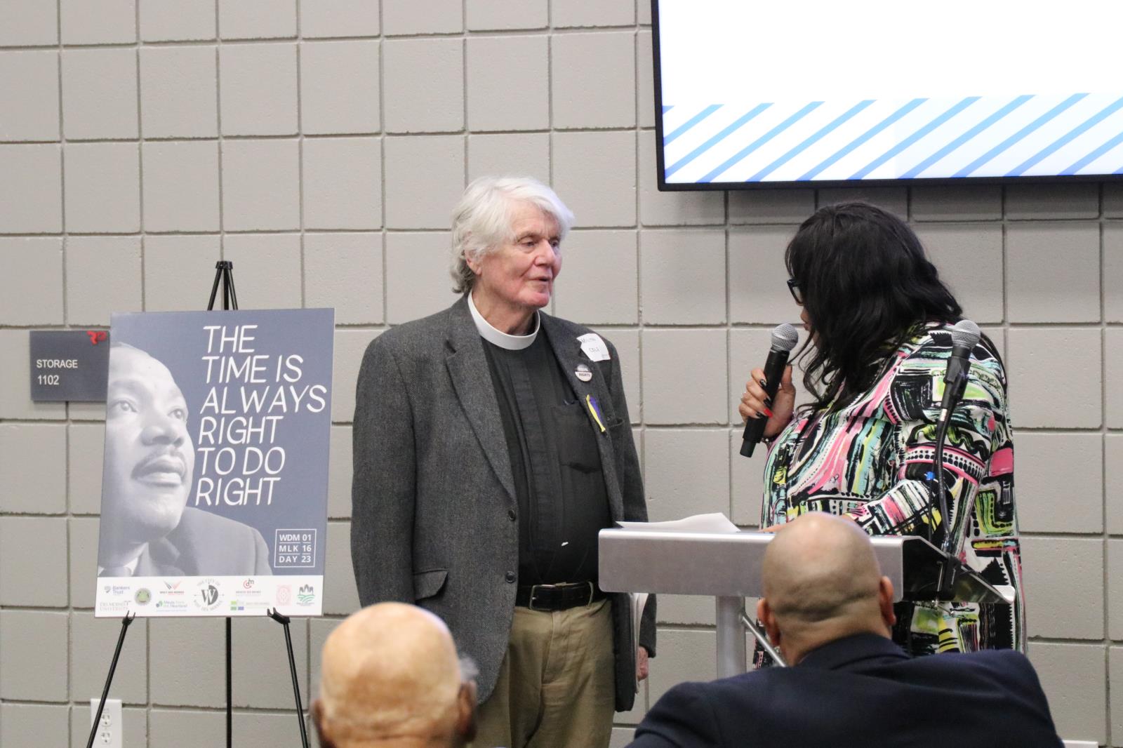 Renee Hardman standing with microphone next to Milton Cole-Duvall