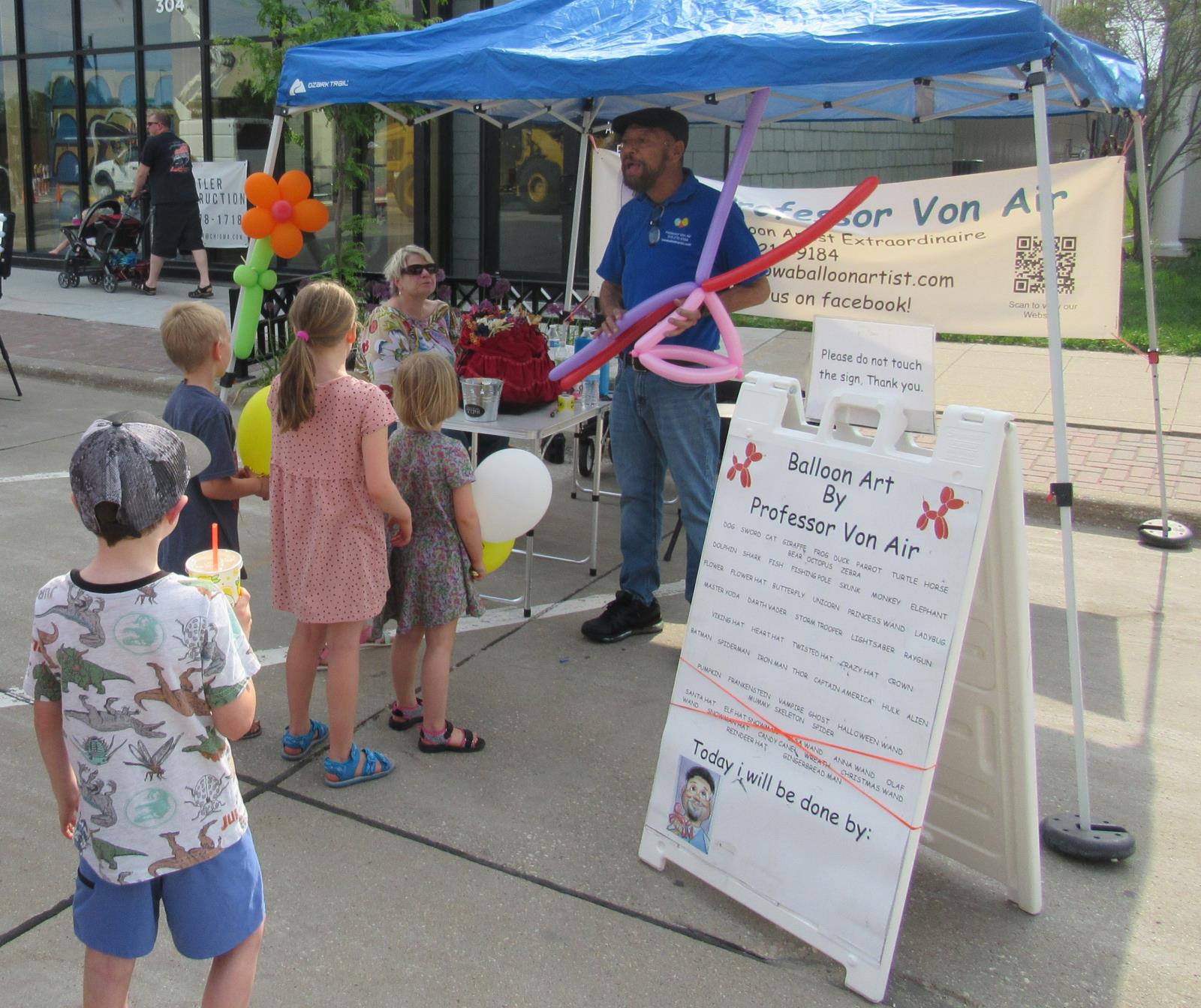 balloon artist creating animal balloons